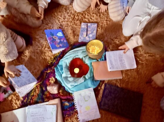 SSC girls sitting in a circle with notebooks