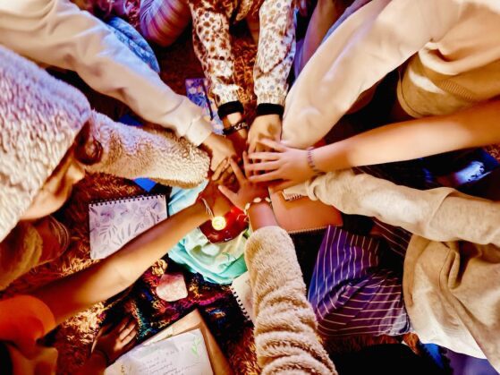 Hands joined in the centre of a circle